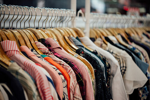 Clothes on hangers in a shop