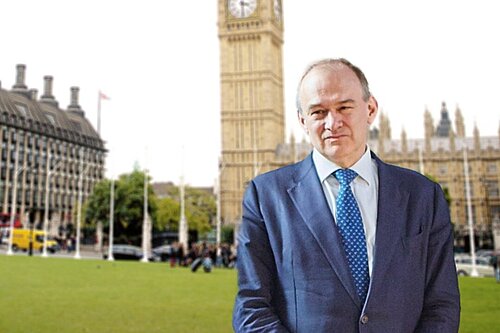 Ed Davey stands outside the Palace of Westminster