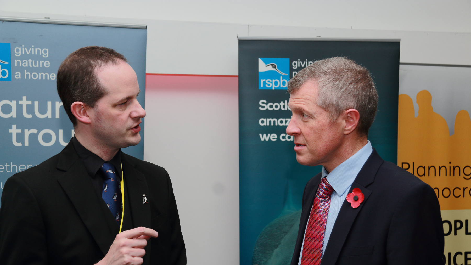 Willie Rennie speaking to someone at conference